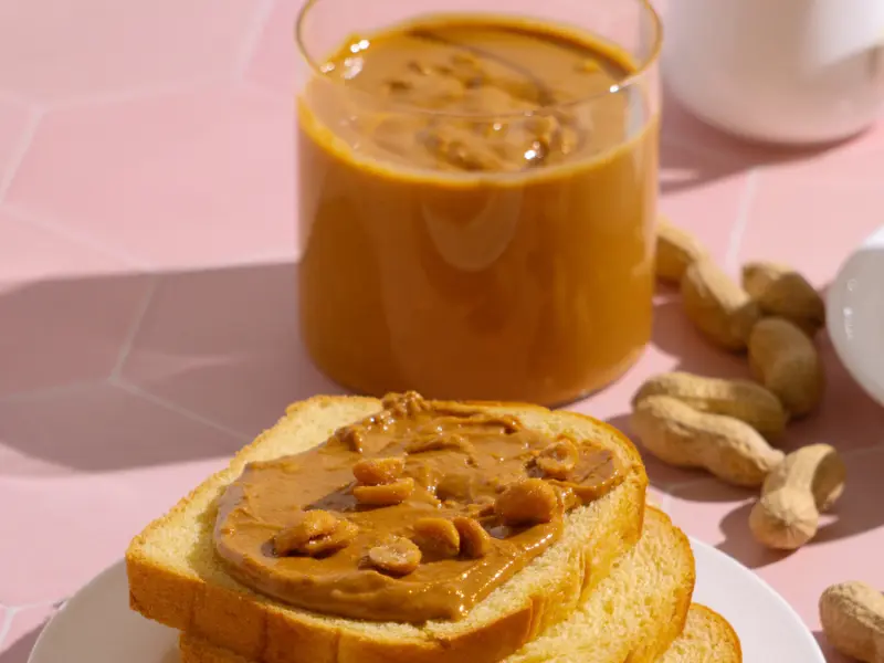 Box Full Of Peanut Butter With Breads And Peanuts Scattered Box full of peanut butter with breads and peanuts scattered