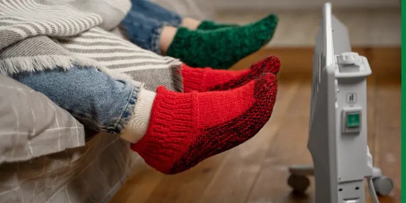 Foot Warmer And Feet Of Two Persons Wearing Socks Foot warmer and feet of two persons wearing socks