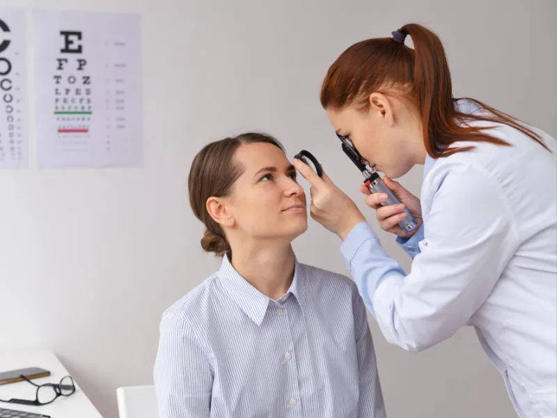 Ophthmoogist Examining The Eye Of A Patient Ophthmoogist examining the eye of a patient