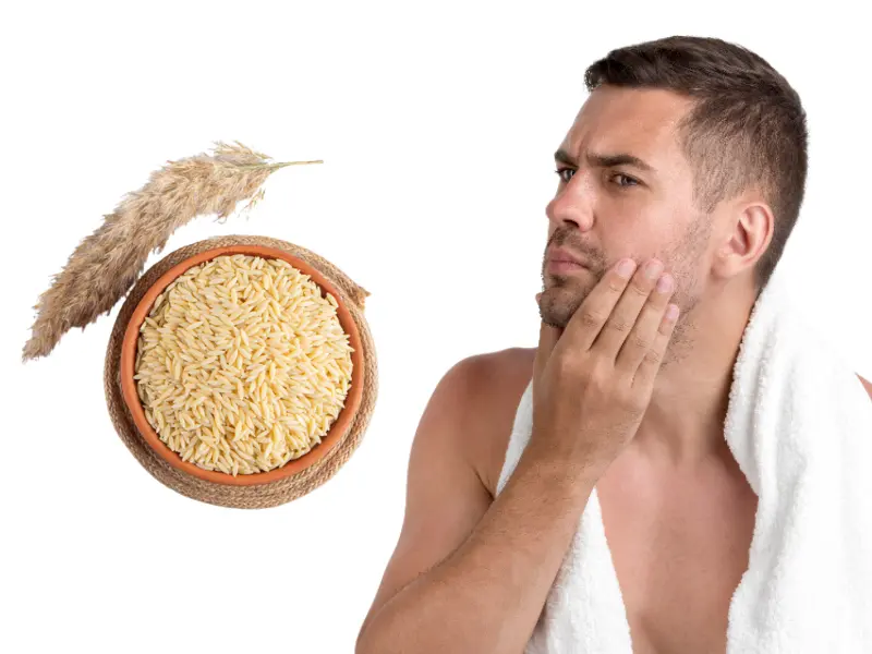 Shirtless Man Wearing Towel Having Acne On Face With One Hand On His Face And A Bowl Of Uncooked Brown Rice Are Placed Nearby Shirtless man wearing towel having acne on face with one hand on his face and a bowl of uncooked brown rice are placed nearby