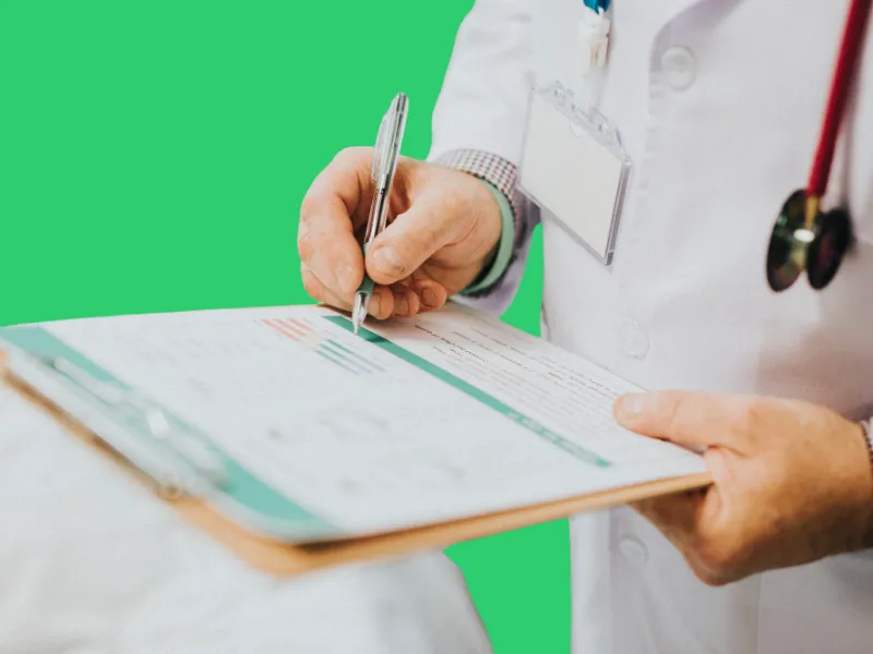 Medical Doctor Is Writing A Medical Report Wearing Stethoscope And White Coat Medical doctor is writing a medical report wearing stethoscope and white coat